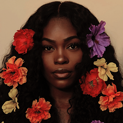 Woman facing forward with flowers in her hair.