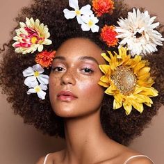 Woman with flowers in her afro.